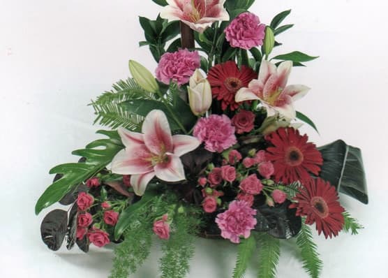 Sympathy arrangement with lilies